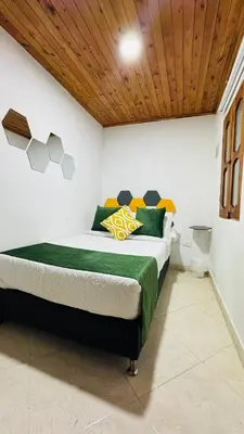 a bedroom with a large bed with a wooden ceiling at JARDIN SECRETO in Jardin