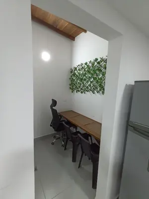 a dining room with a wooden table and chairs at Apartamento El Trébol 101 in Jardin