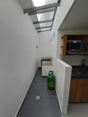 a kitchen with a green trash can on the floor at Apartamento El Trébol 101 in Jardin