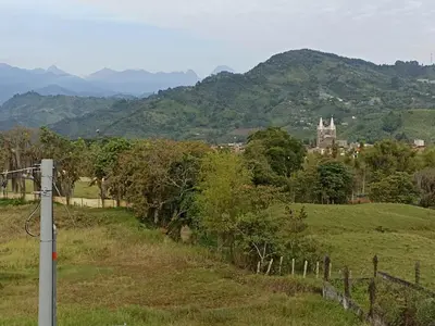 a field with a fence and a castle in the distance at Apartamento El Trébol 101 in Jardin