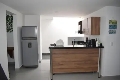 a kitchen with a counter and a refrigerator in it at Apartamento El Trébol 101 in Jardin