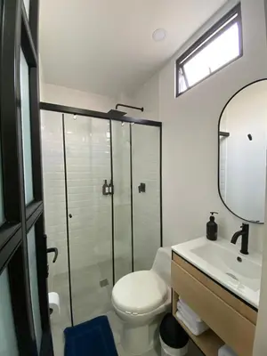 a bathroom with a shower and a toilet and a sink at 80Cooliving Medellín in Medellín