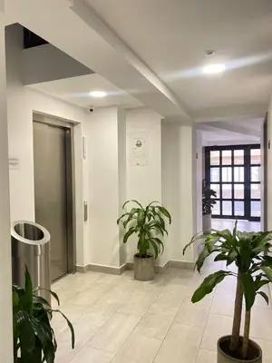 a hallway with two potted plants in a building at 80Cooliving Medellín in Medellín