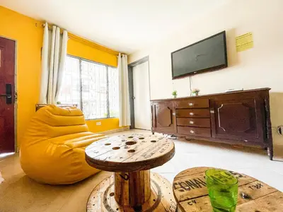 a living room with a couch and a table at Casa Clandestina Guest House in Medellín