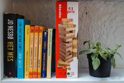 a group of books on a shelf next to a plant at Casa Clandestina Guest House in Medellín