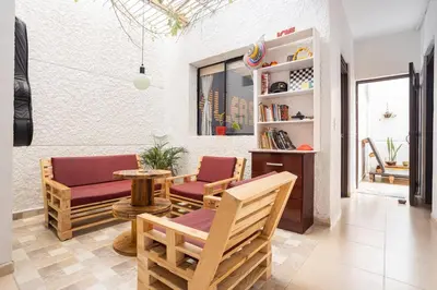 a living room with two chairs and a table at Casa Clandestina Guest House in Medellín