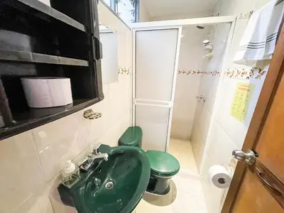 a bathroom with a green sink and a toilet at Casa Clandestina Guest House in Medellín