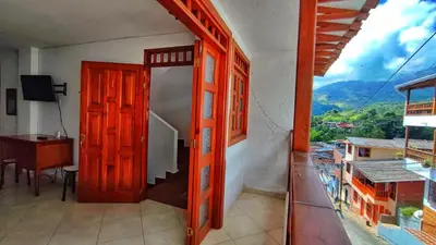 an open door to a room with a desk and a window at Apartamentos con estacionamiento cerca al parque in Támesis