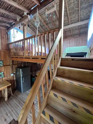 a wooden staircase in a room with a bunk bed at Cabañas Villa Juliana in Jardin