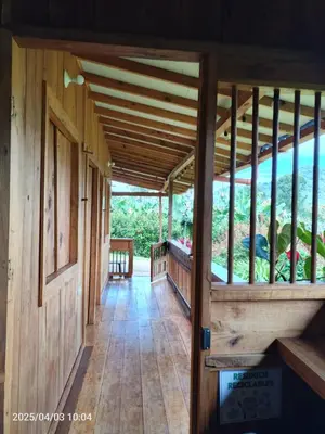 an inside view of a wooden house with a porch at Cabañas Villa Juliana in Jardin