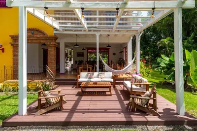 a patio with couches and a hammock on a house at Casa Etnika in Jericó