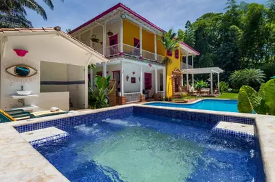 a house with a swimming pool in front of a house at Casa Etnika in Jericó