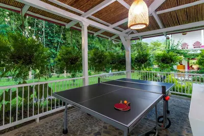 a ping pong table on a porch with a ceiling at Casa Etnika in Jericó