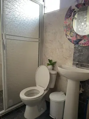 a bathroom with a toilet and a sink and a shower at Finca campestre mi retoño in Medellín