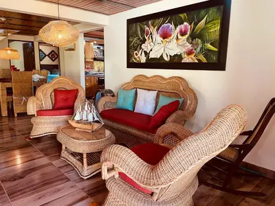 a living room with wicker chairs and couches at Finca campestre mi retoño in Medellín