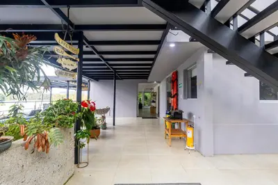 an office with a hallway with plants at Cabaña familiar BANIA con vista del embalse al lado de la piedra in Guatapé