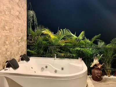a white bath tub in a bathroom with plants at Verdes Hábitat Glamping in Palestina