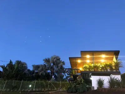 a house with lights on it at night at Verdes Hábitat Glamping in Palestina