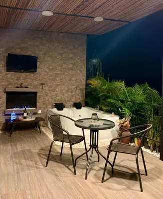 a room with a table and chairs and a fireplace at Verdes Hábitat Glamping in Palestina