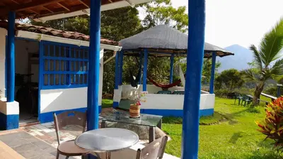 a blue and white house with a table and chairs at Casa Horizontes in San Carlos