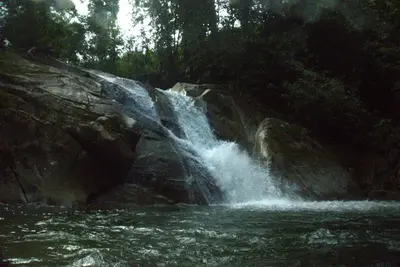 a waterfall in the middle of a river at Casa Horizontes in San Carlos