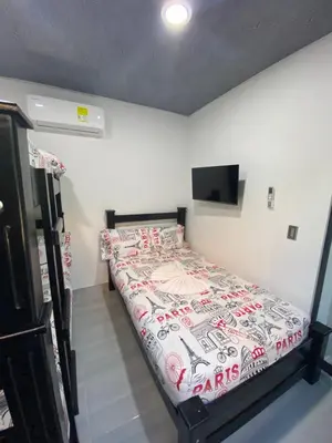 a small bedroom with a bed with a baseball bedspread at Apartamento vacacional Galeon Doradal in Doradal