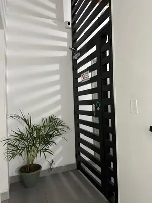 a black door with a plant in a room at Aparta estudio amoblado 4 Medellín, San Joaquín in Medellín
