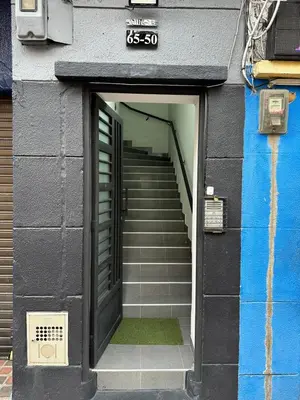 a stairway leading up to a building with a door at Aparta estudio amoblado 4 Medellín, San Joaquín in Medellín
