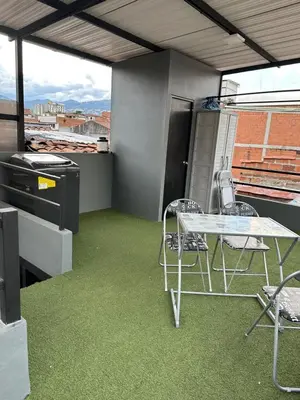 a patio with a table and chairs on a balcony at Aparta estudio amoblado 4 Medellín, San Joaquín in Medellín