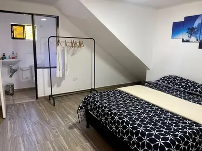 a bedroom with a black and white bed in a room at BERAKHAH SPA & ROOMS in Guatapé