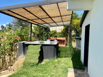 a pergola on the side of a house at BERAKHAH SPA & ROOMS in Guatapé