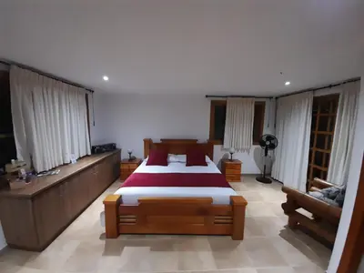 a bedroom with a large bed and a couch at Casa Chute in Chinchiná
