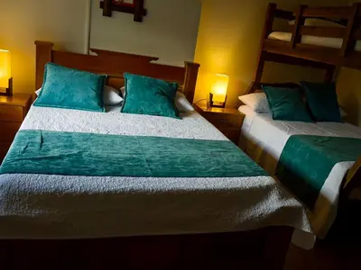 two beds in a bedroom with two bunk beds at Casa Chute in Chinchiná