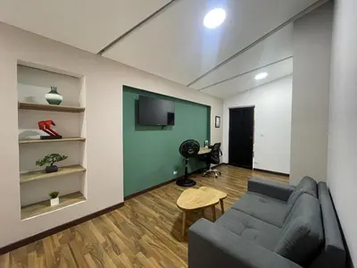 a living room with a couch and a flat screen tv at Apartamento en Medellín sector del Poblado A101 By Roots Rentals in Medellín