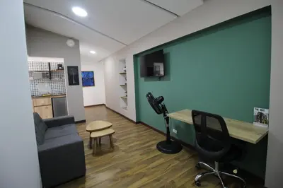 an office with a desk and a chair and a microphone at Apartamento en Medellín sector del Poblado A101 By Roots Rentals in Medellín