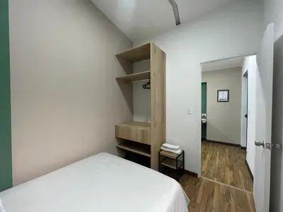 a bedroom with a bed and a book shelf at Apartamento en Medellín sector del Poblado A101 By Roots Rentals in Medellín