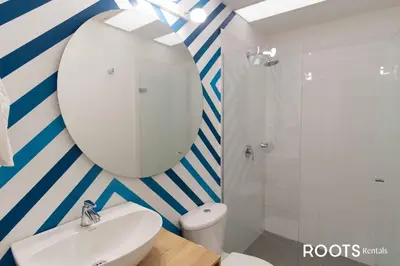 a bathroom with a white sink and a mirror at Apartamento en Medellín sector del Poblado A101 By Roots Rentals in Medellín