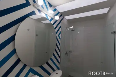 a bathroom with a mirror and a shower at Apartamento en Medellín sector del Poblado A101 By Roots Rentals in Medellín