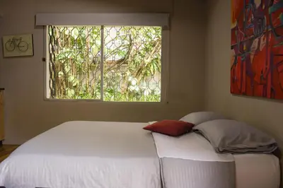 a bed with two pillows in a bedroom with a window at Alojamiento que permite mascota en Medellín A103 By Roots Rentals in Medellín