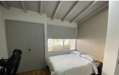 a bedroom with a bed and a window at Apartamento cerca al centro comercial Santafé A105 By Roots Rentals in Medellín