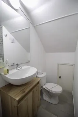 a white bathroom with a sink and a toilet at Cómodo aparta suite en zona Poblado Medellín M101 By Roots Rentals in Medellín