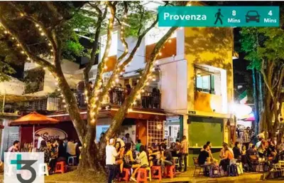 a group of people sitting outside of a restaurant at Económica Suite en sector Manila el Poblado M102 By Roots Rentals in Medellín