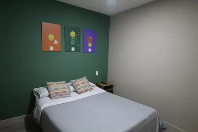 a bedroom with a white bed with two pillows at Económica Suite en sector Manila el Poblado M102 By Roots Rentals in Medellín