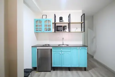 a kitchen with blue cabinets and a sink at Económica Suite en sector Manila el Poblado M102 By Roots Rentals in Medellín