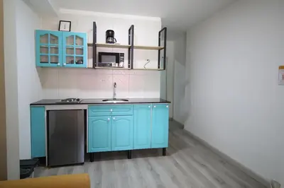 a kitchen with blue cabinets and a sink at Económica Suite en sector Manila el Poblado M102 By Roots Rentals in Medellín