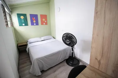 a room with a bed and a fan in it at Hospedaje cerca a Provenza en el Poblado - M301 By Roots Rentals in Medellín