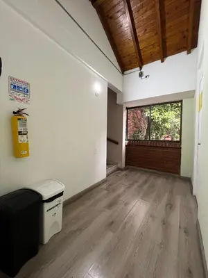 an empty room with wooden floors and a large window at Hospedaje cerca a Provenza en el Poblado - M301 By Roots Rentals in Medellín