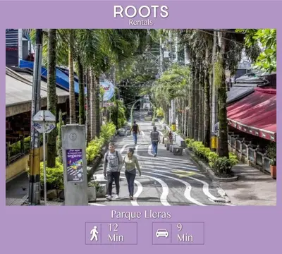 a group of people walking down a street with palm trees at Hospedaje cerca a Provenza en el Poblado - M301 By Roots Rentals in Medellín