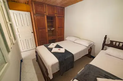 a bedroom with two beds with towels on the bed at Casa Los Patios in Jericó