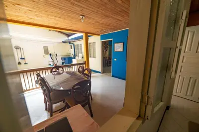 a dining room with a table and chairs on a balcony at Casa Los Patios in Jericó